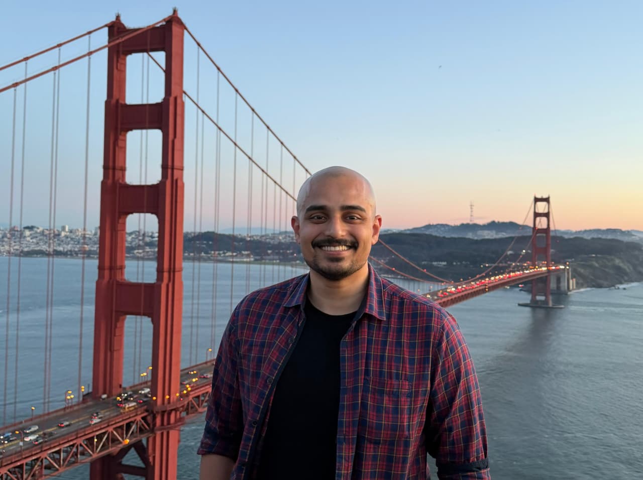 Ansel Dias in front of the Golden Gate Bridge at dusk